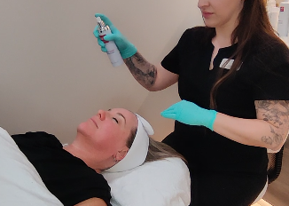 Aesthetician enhancing a patients skin with a medical grad facial